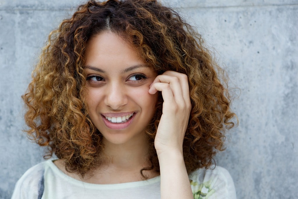 Woman with short curly hair in transition