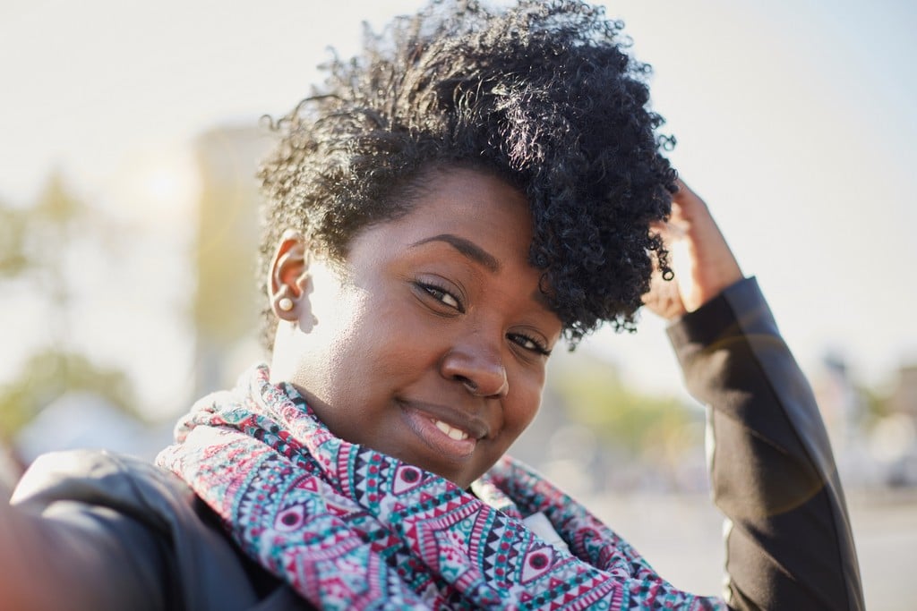 Woman with curly hair Mohawk style