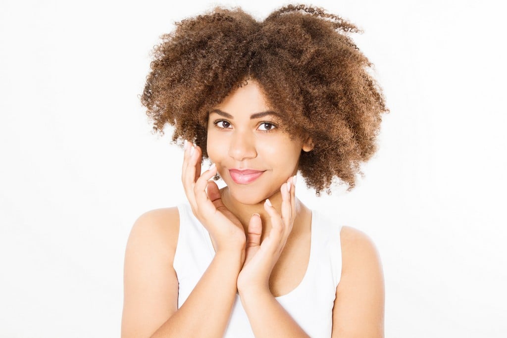 Young woman with curly hair in transition