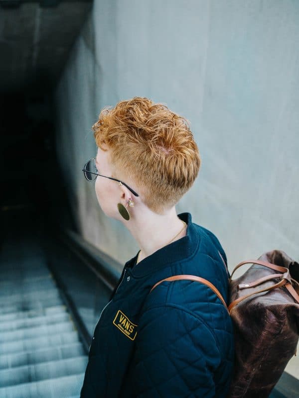 Short red hair with a side cut with the nape of the neck beating