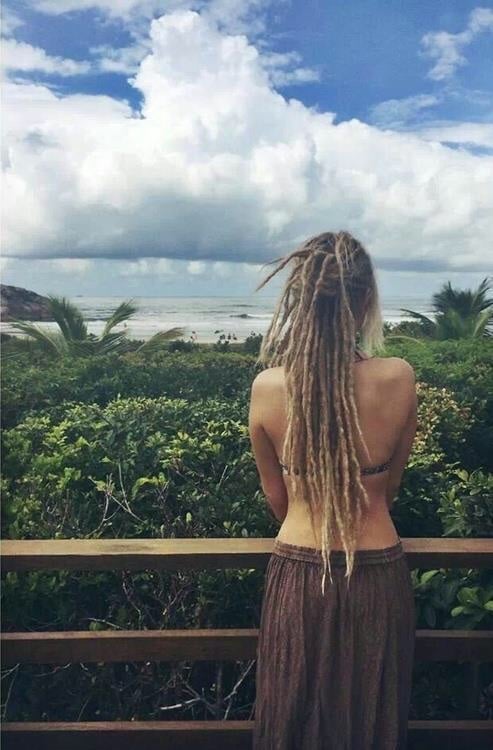 Woman on the beach with dread in her hair