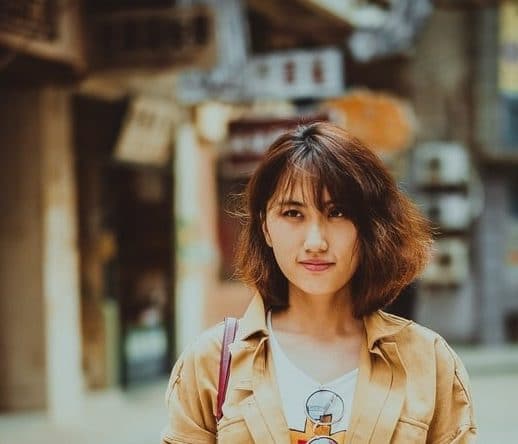 Woman with straight hair and short fringe cut