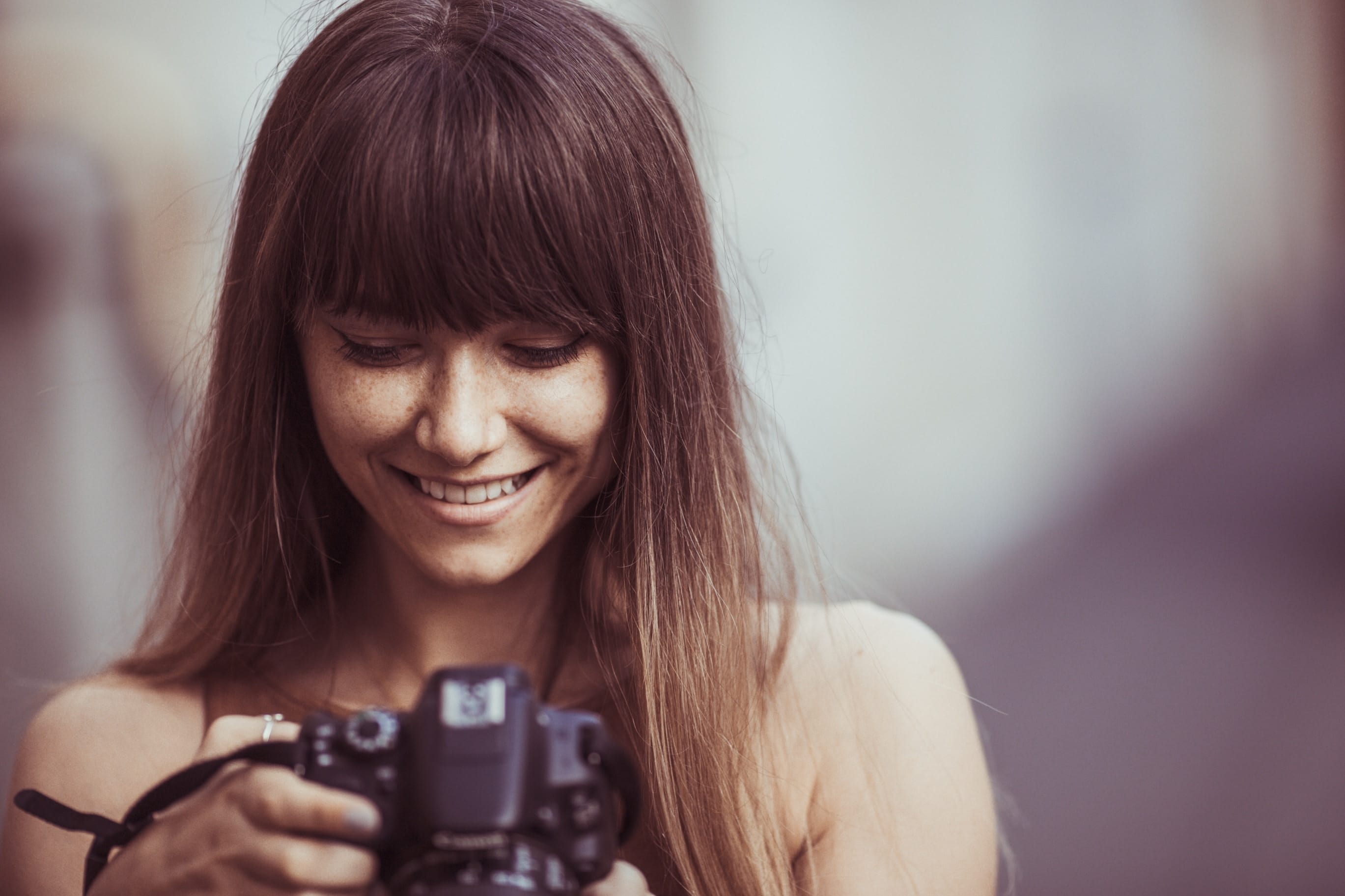 Woman with half-moon fringe cut and straight hair 