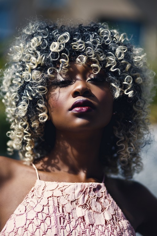 Woman with curly hair, fringe cut