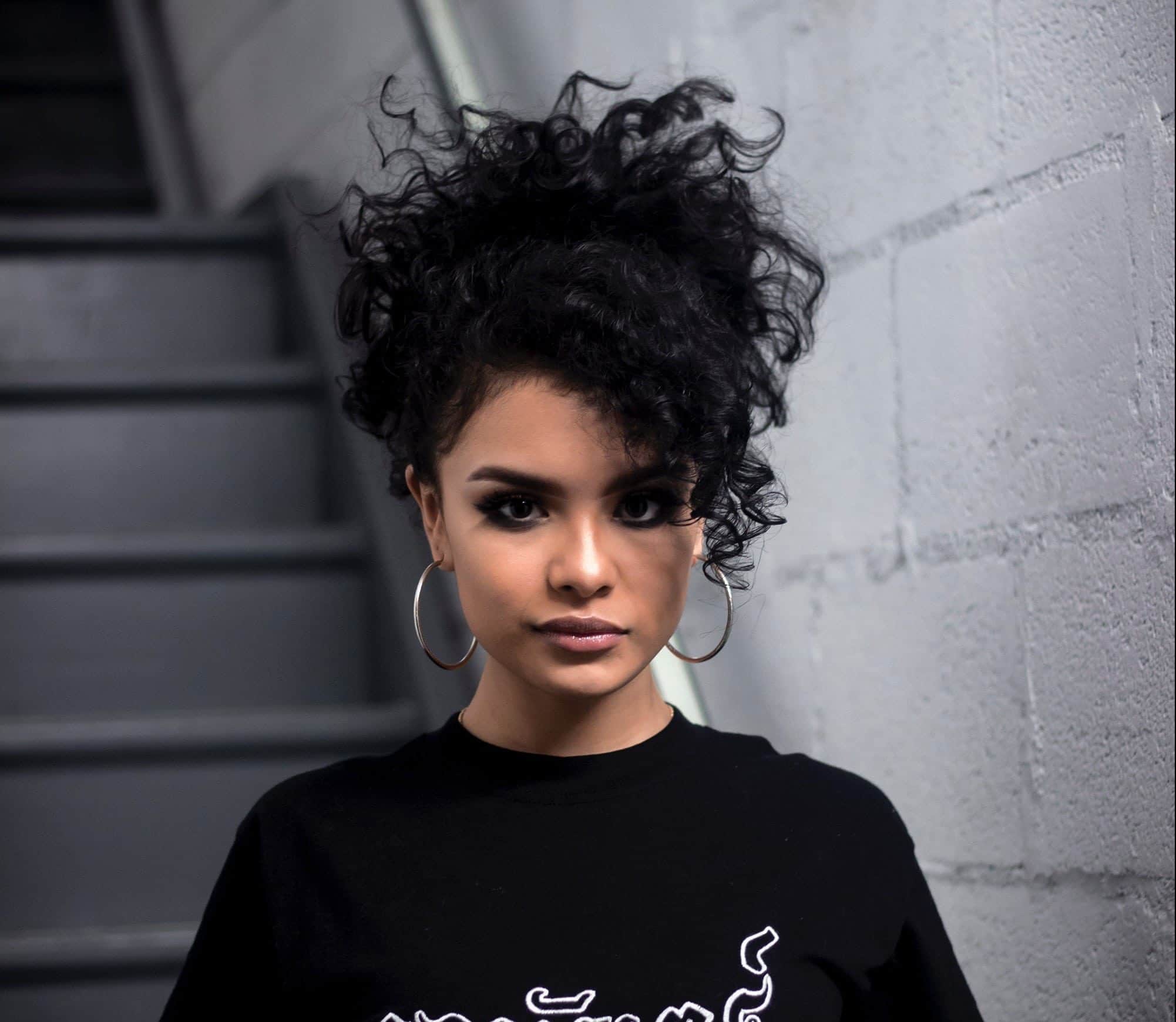 Woman with curly hair with diagonal fringe