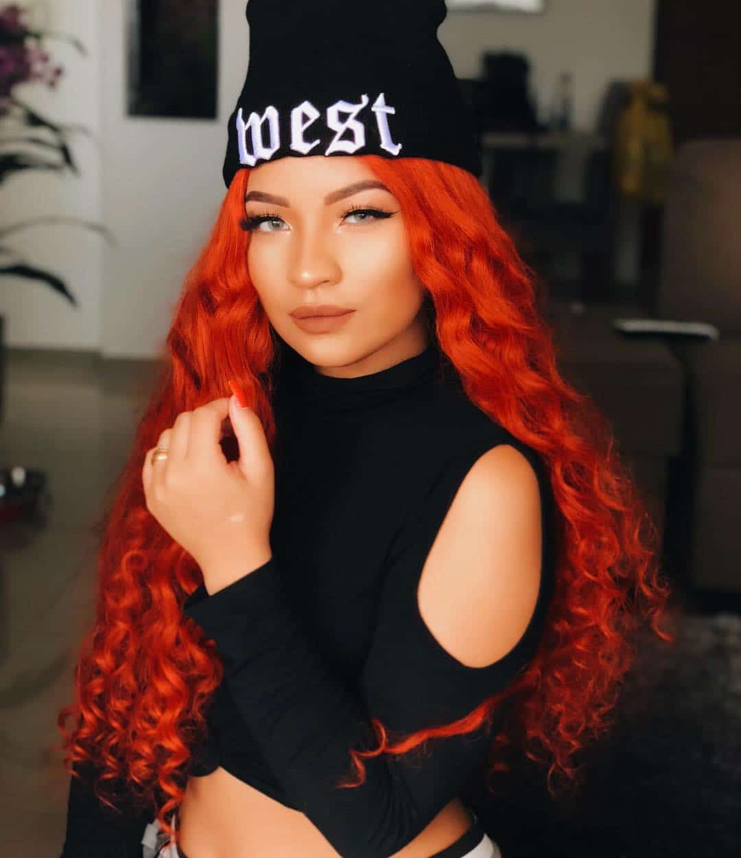 Hat model as an accessory showing her long wavy red hair well-kept