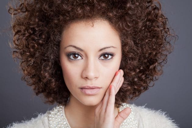 Black woman with curly and brunette hair