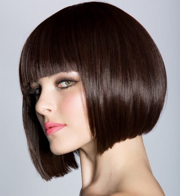 white woman with short brunette hair with frontal bangs