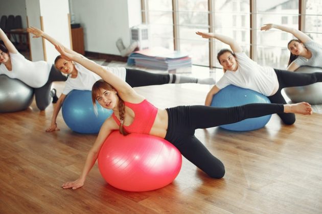 women exercising on pilates ball